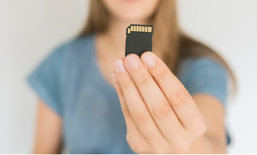 A hand holding SD Card